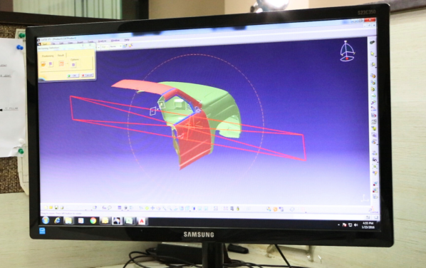 Computer monitor displaying a 3D CAD model of an automotive part in ALP Nishikawa's design process.